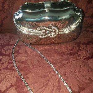 Silver jeweled  formal clutch with silver strap.